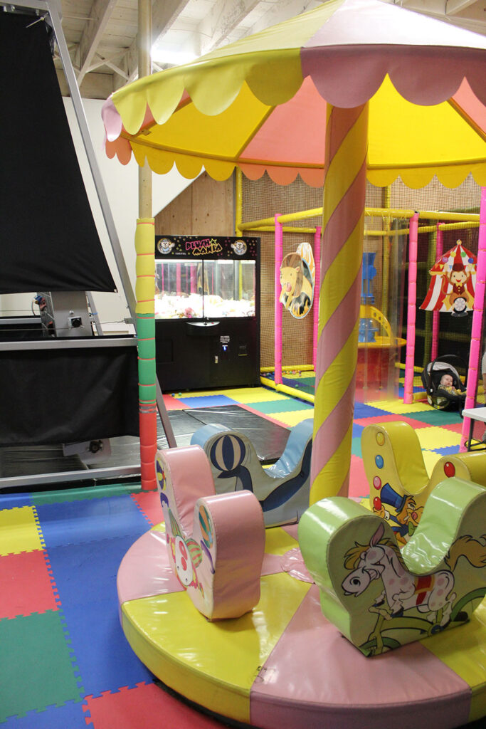 Merry-go-round and claw machine in the background